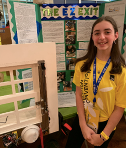 Abigail poses with her invention prototype and display board.