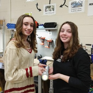 Nicolette and Lauren pose with their invention prototype.
