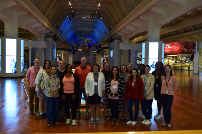 Group photo in front of the Cornterstone of the 2023 Educators in Residence